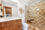 En suite has a beautiful tile shower with shower seat